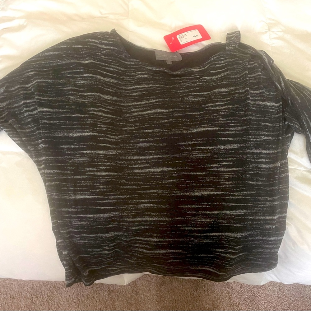 Beautiful top can be dressed up or worn with jeans. One side shows shoulder.